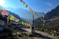 Prayer flags hang along a path in a Nepalese village