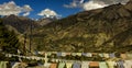 Prayer flags and nepal valley with farm fields and villages and great mountains Royalty Free Stock Photo