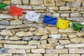 Prayer flags on stone wall