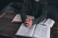 Prayer. A group of Christians pray holding hands. On the table. The Holy Bible is open. Praying