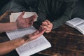 Prayer. A group of Christians pray holding hands. On the table. The Holy Bible is open. Praying Royalty Free Stock Photo