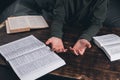 Prayer. A group of Christians pray holding hands. On the table. The Holy Bible is open. Praying