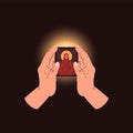 Prayer hands, surrounded by divine light, hold the sacred icon and symbolize worship, faith and spirituality