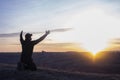 Prayer. Man on his knees praying. Against the background of the sky and sunset. Forgiveness of sins and repentance. Easter Royalty Free Stock Photo