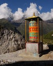 Buddhist prayer mill and the Himalayas in the background Royalty Free Stock Photo