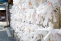 Prayer Papers Tied to Rope in Japanese Shrine - Spiritual Tradition and Sacred Offerings