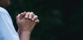 Prayer person hand in black background. Christian catholic woman are praying to god in dark at church. Girl believe and faith in