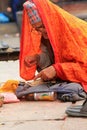 A prayer reciting a holy book at Kumbeshwar Temple, Nepal