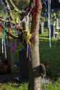 Prayer ribbons on a tree in a graveyard cemetery Royalty Free Stock Photo
