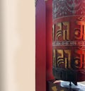 Prayer wheel with bell with language of TIbet named Tibetan, A cylindrical wheel, mantra Om Mani Padme Hum , Vertical image with Royalty Free Stock Photo