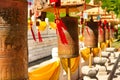 Buddhist prayer wheels in front of the temple are jade-gold statues of the goddess Guanyin in the Nanshan Buddhism Center. Hainan