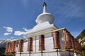 Prayer wheels and a small white pagoda near the Mati Temple in Gansu province in China.