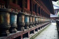 prayer wheels spinning in a row at a temple