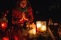 prayer woman. Candles in the cemetery. 1st November. Feast of All Saints. Hallowmas. All Souls& x27; Day.