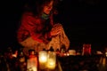 prayer woman. Candles in the cemetery. 1st November. Feast of All Saints. Hallowmas. All Souls& x27; Day.