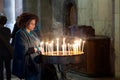 Prayers christian lighting candles in the Holy Sepulcher Church in Jerusalem, Israel. Royalty Free Stock Photo