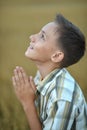 Praying boy in field