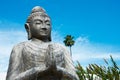 Praying buddha on blue sky Royalty Free Stock Photo