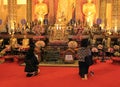 Praying at a buddhist temple, Thailand Royalty Free Stock Photo