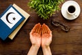 Praying concept with hands, Koran Islam holy book, crescent and star on wooden table top view