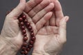 Praying female hands with rosary