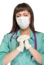 Praying female medical doctor with mask isolated