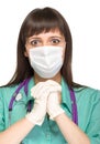 Praying female medical doctor with mask isolated