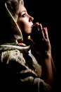 Praying girl with shawl on head. Retouched Royalty Free Stock Photo