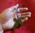 Praying hand with Celtic style cross on red background