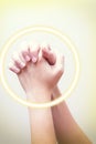 Praying hand sign, two woman`s palm are clasped all together. wifh golden circle wave on hands hand language concept Royalty Free Stock Photo