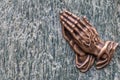 Praying hands as bronze figure on a graveyard grave as religious symbol for faith christianity blessing catholic priest and belief Royalty Free Stock Photo