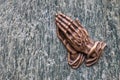 Praying hands as bronze figure on a graveyard grave as religious symbol for faith christianity blessing catholic priest and belief Royalty Free Stock Photo