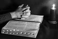 Praying hands and bible with candle Royalty Free Stock Photo