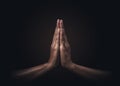 Praying hands with faith in religion and belief in God on dark background. Power of hope or love and devotion. Namaste or Namaskar