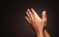 Praying hands with faith in religion and belief in God on dark background. Power of hope or love and devotion. Namaste or Namaskar Royalty Free Stock Photo