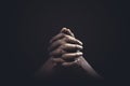 Praying hands with faith in religion and belief in God on dark background. Power of hope or love and devotion Royalty Free Stock Photo