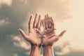Praying hands hold a crucifix or cross of metal necklace with faith in religion and belief in God on confession background. Power Royalty Free Stock Photo