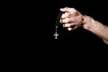 Praying hands holding a rosary with cross Royalty Free Stock Photo