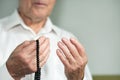 Praying hands of an old man holding rosary beads Royalty Free Stock Photo