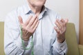 Praying hands of an old man holding rosary beads Royalty Free Stock Photo