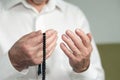 Praying hands of an old man holding rosary beads Royalty Free Stock Photo