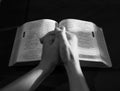 Praying hands on open bible Royalty Free Stock Photo