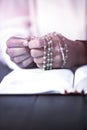 Praying hands of woman with rosary and bible Royalty Free Stock Photo