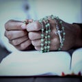 Praying hands of woman with rosary and bible Royalty Free Stock Photo