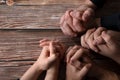 Praying hands on a wooden background with copy space, top table view Royalty Free Stock Photo