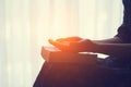 Praying hands, young woman prayer  with hands together over a Holy Bible Royalty Free Stock Photo