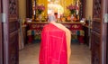 Praying monk from behind, on his knees