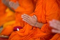 Praying monk hand with tattoo