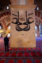 Praying muslim man behind a pillar of Old Mosque in Edirne