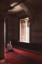 Praying muslim man in the mosque. Ramadan or islamic vertical photo.
